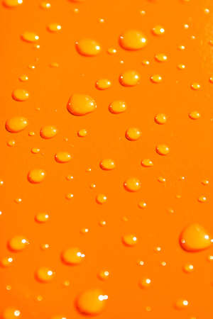 water drops on orange metal macro backgroundの写真素材