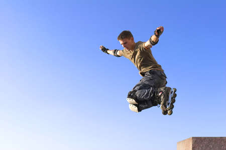 active roller boy jumping on sky