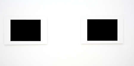Two empty frames on white wall in museumの写真素材