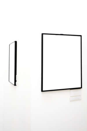 Two empty frames on white wall in museumの写真素材