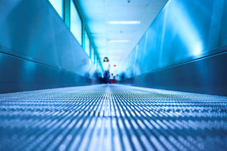 Blue moving escalator in the office hall perspective viewの写真素材