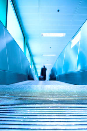 Blue moving escalator in the office hall perspective viewの写真素材