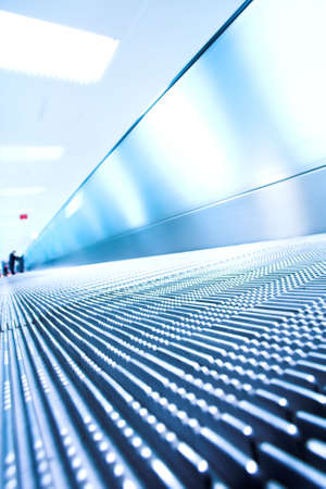 Blue moving escalator in the office hall perspective viewの写真素材