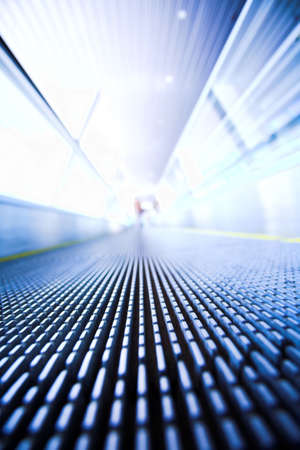 Blue moving escalator in the office hall perspective viewの写真素材