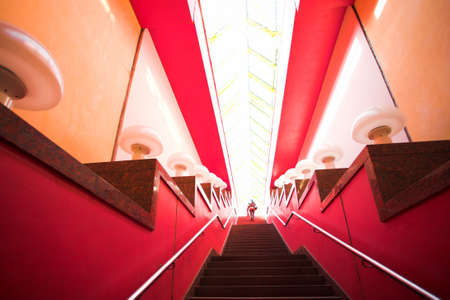 Red interior stair and people movingの写真素材
