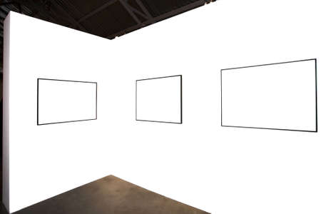 Three empty frames on white wall in museumの写真素材