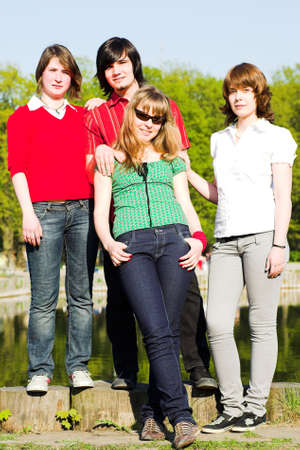 Four teen friends in parkの写真素材