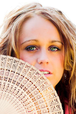Smiling closed beautiful girl with fanの写真素材