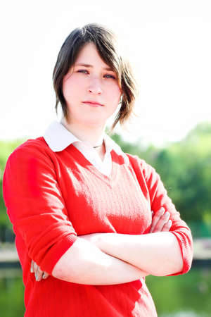 Smiling girl in red portrait outdoorの写真素材