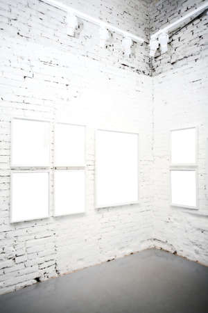 brick wall in museum with empty framesの写真素材