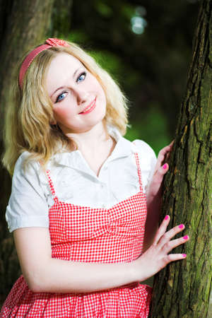 Blonde smile beautiful girl portrait near treeの写真素材