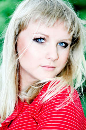 Smile teen girl in red in parkの写真素材