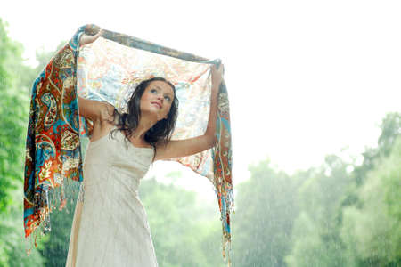 Girl stay under rain drops cover shawlの写真素材