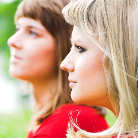 Two girls in red in parkの写真素材