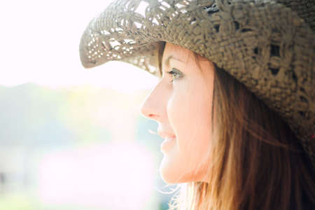 profile of beautiful smiling girl in hatの写真素材