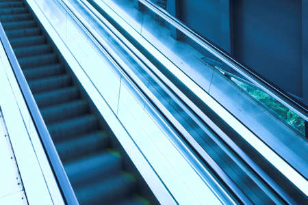 Blue move escalator in modern office centreの写真素材