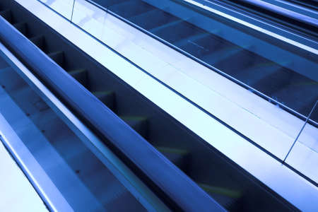 Blue move escalator in modern office centreの写真素材