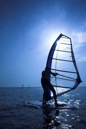 Surfer on sunset on wavesの写真素材
