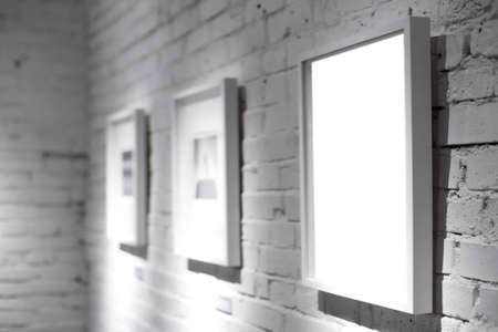 Three frames on white wallの写真素材