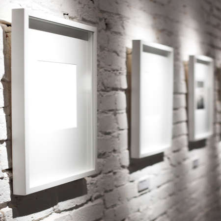 Three frames on white wallの写真素材