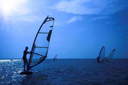 Surfer on sunshine on wavesの写真素材