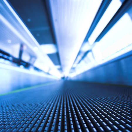 Blue moving escalator in the office hall perspective viewの写真素材
