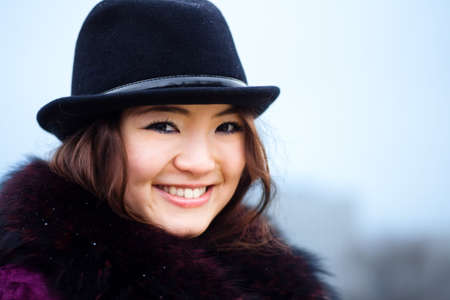 Oriental girl in coat smile portrait