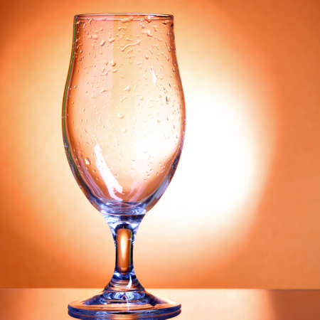 Empty beer glass and light rayの写真素材