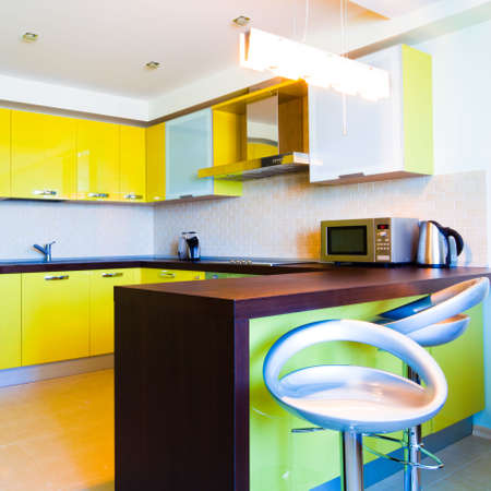 Yellow kitchen interior with chairs in modern flat,square compositionの写真素材