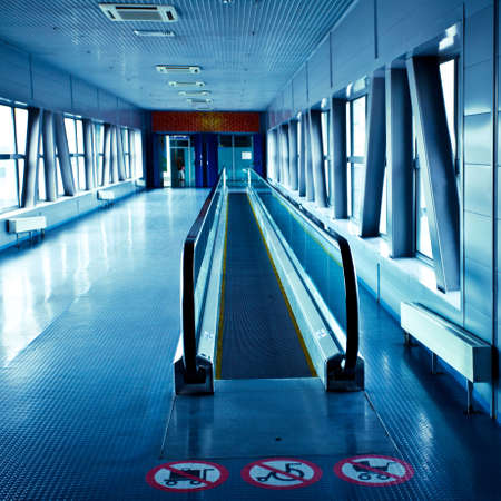 Empty blue escalator view in corridor in modern office centre