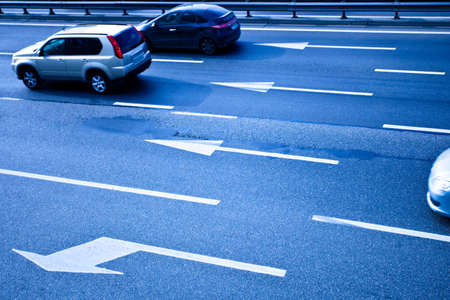 Cars on asphalt road with poits in blue