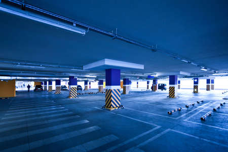 View to empty parking with several autos in blueのeditorial素材