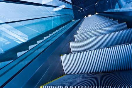 Escalator in blue corridor in office centre