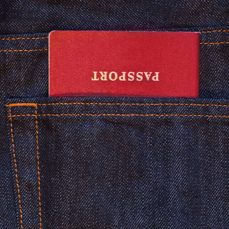 Dark blue jeans pocket with red passport in itの写真素材
