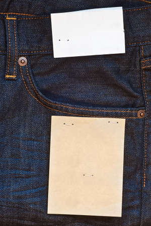 Dark blue jeans with two empty paper labelsの写真素材