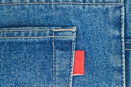 Blue old jeans pocket with empty red label close-upの写真素材