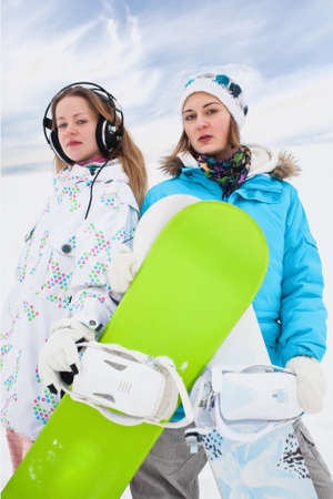 Couple modern  fun snowborder girls in mouintains の写真素材