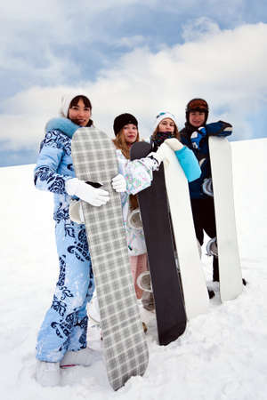 Four fun snowborders stay in mouintainsの写真素材