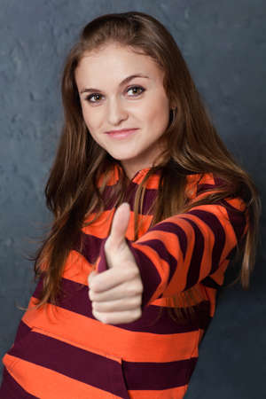 Portrait of young girl showing gesture All right!の写真素材