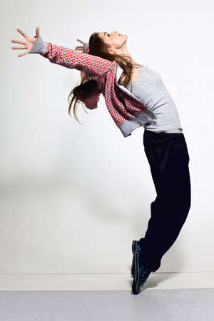 Portrait of young jumping girl with backgroundの写真素材
