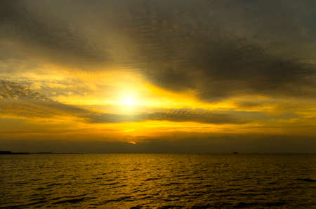 Amasing sunset  Dark dramatic clouds under the pacific seaの写真素材