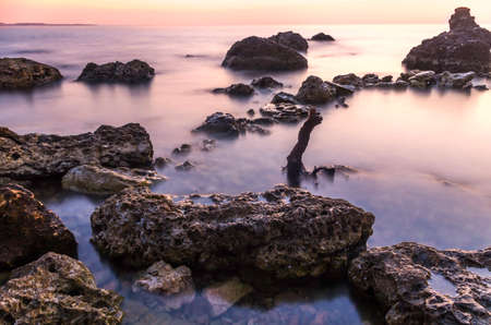 Moody sunset on the calm lakeの写真素材