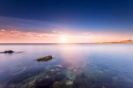 Sunset over the silky waterの写真素材