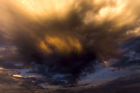 storm cloud hanging ominously above the groundの写真素材