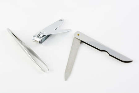 Nail cutter nail file and pincer over white backgroundの写真素材