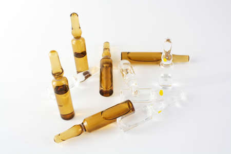 Brown and transparent vials ampules over white backgroundの写真素材