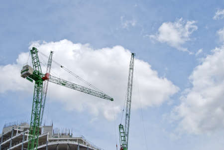 Two Green Heavy Lift Tower Cranes on a construction Siteのeditorial素材