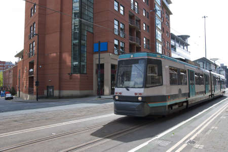 A Modern Green and White Tram on a city Streetのeditorial素材
