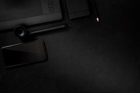 Office leather desk table with digital drawing tablet, supplies and smartphone. Top view with copy spaceの写真素材
