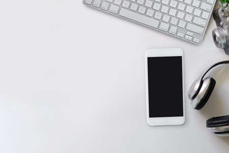 White office desk table with creative stuff. Top view with copy space, flat lay or hero header...